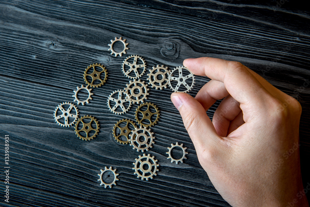 concept hour metal gears on wooden background top view