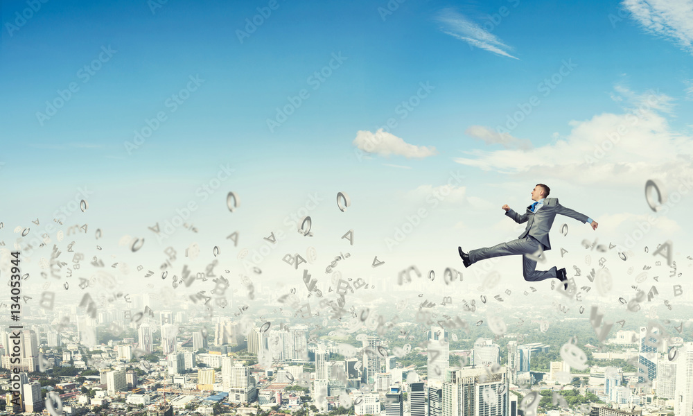 Businessman jumping high