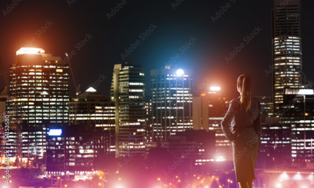 Woman looking at night city