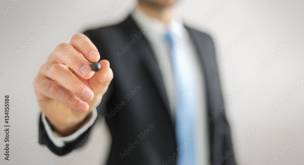 Businessman writing with a pen on a digital screen