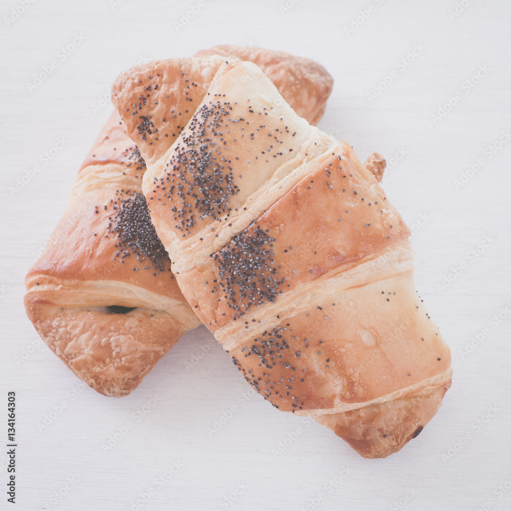 Fresh and tasty croissant over white background