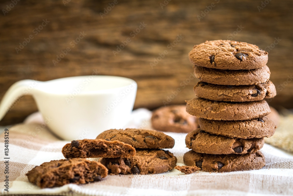 Close up stacked chocolate chip cookies on  napkin 