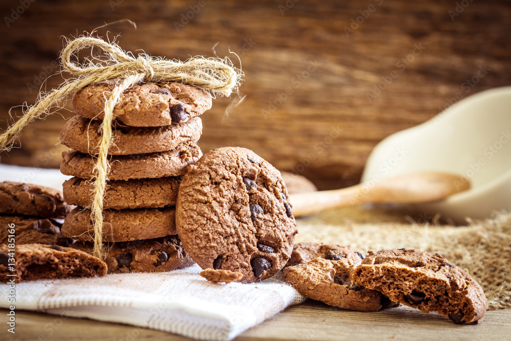 Close up stacked chocolate chip cookies on  napkin 