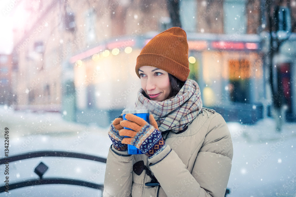 A girl holding a thermos with a hot drink