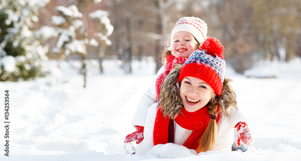 happy family mother and child playing on winter walk