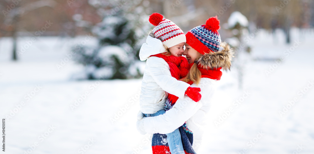 happy family mother and child playing on winter walk