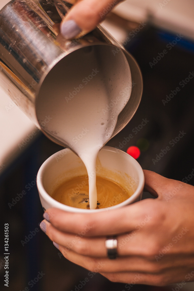 Closeup of hands making espresso