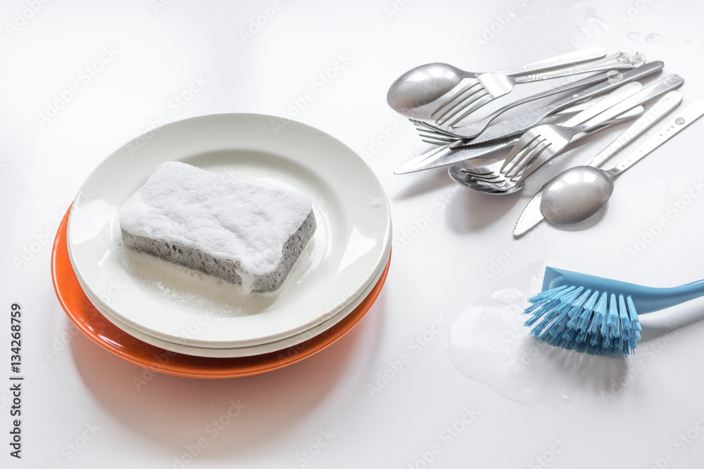 concept of washing dishes on white background top view