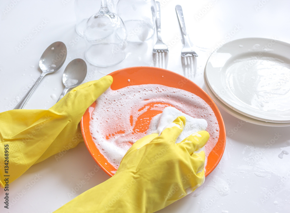 concept of woman washing dishes on white background