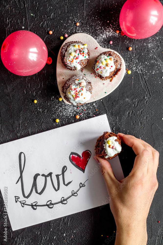 concept of Valentines Day cupcakes dark background top view