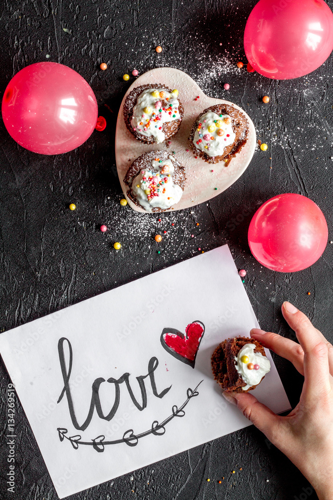 concept of Valentines Day cupcakes dark background top view