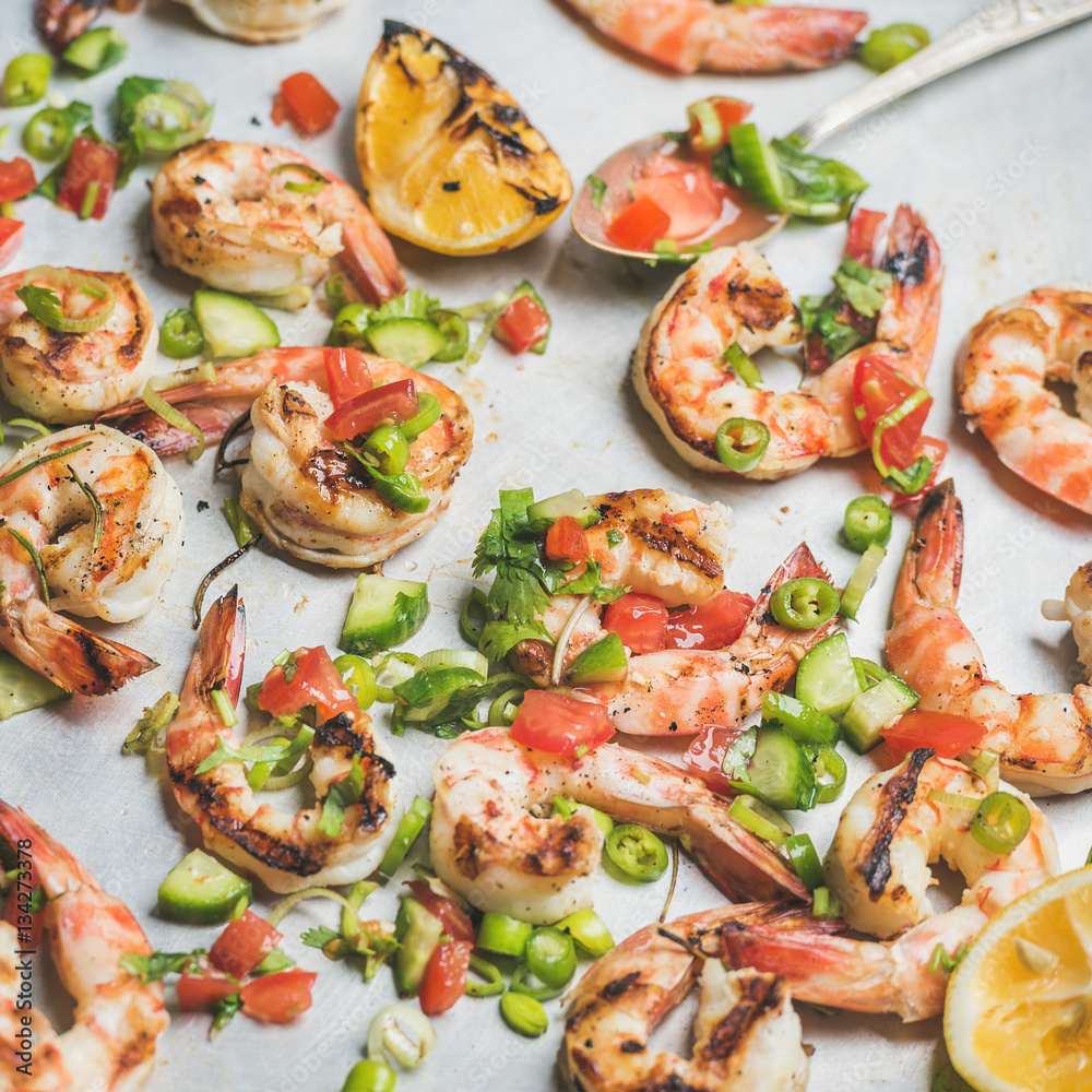 Seafood dinner. Close-up of grilled tiger prawns with leek, chili pepper, lemon and mint salsa sauce