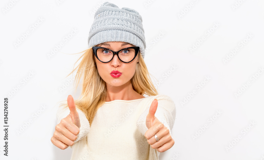 Happy young woman giving thumbs up