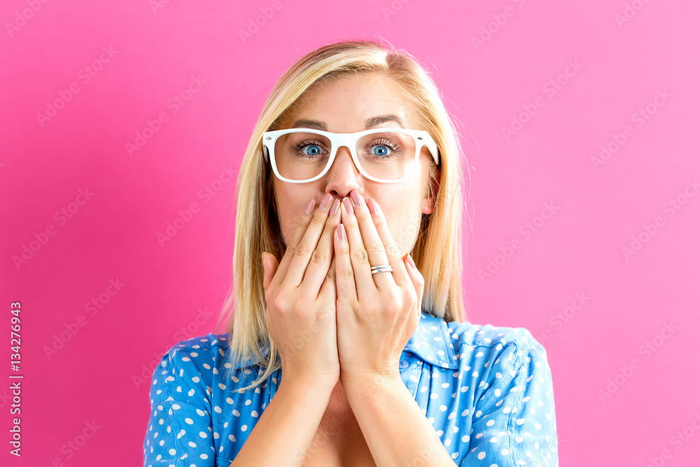 Young woman covering her mouth