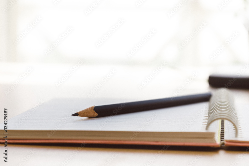 a blank reporters notepad notebook with pencil