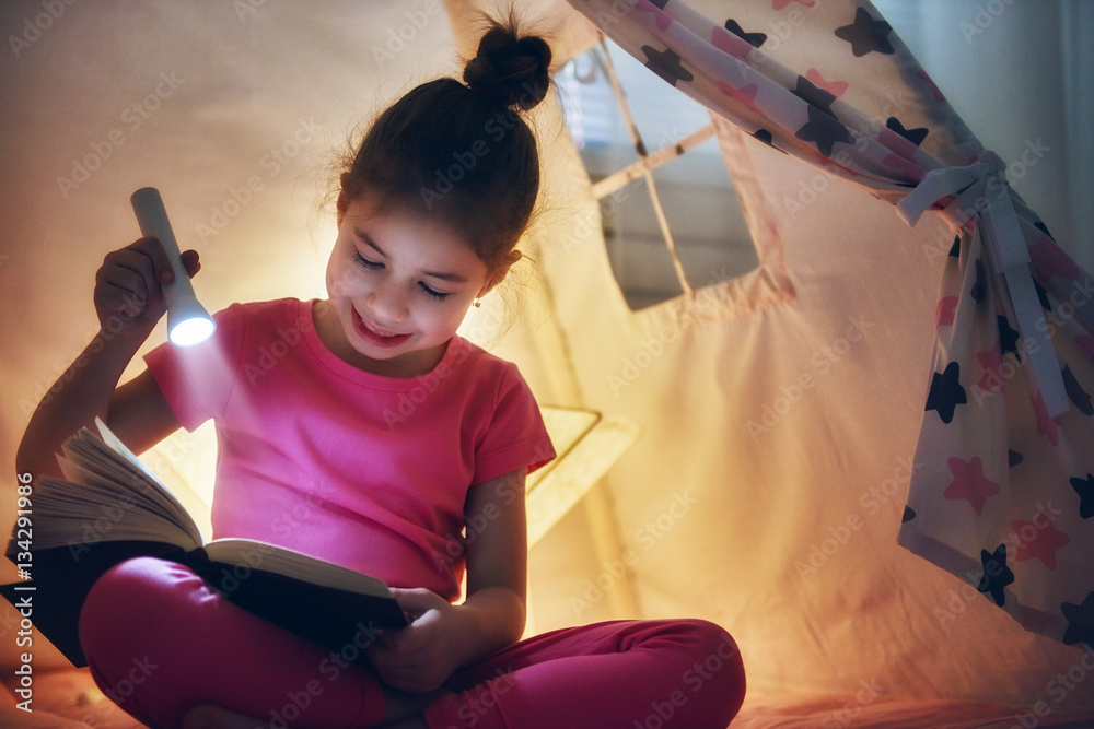 child is reading a book