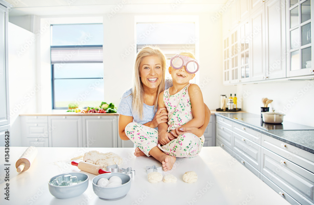 Cute mother and daughter in kitchen