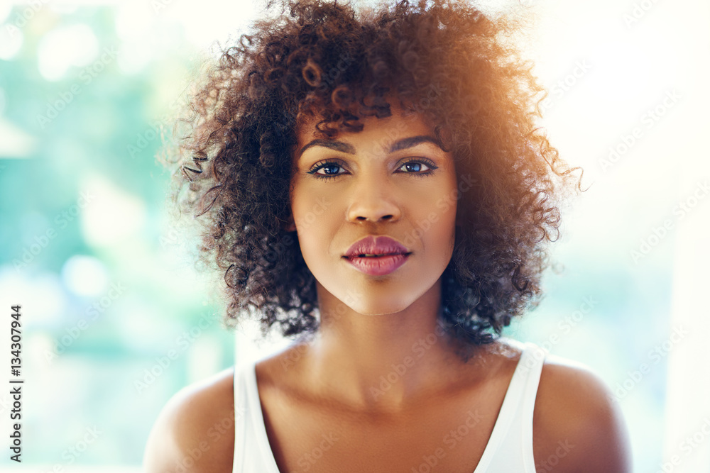 Thoughtful young black woman with sunlight flare