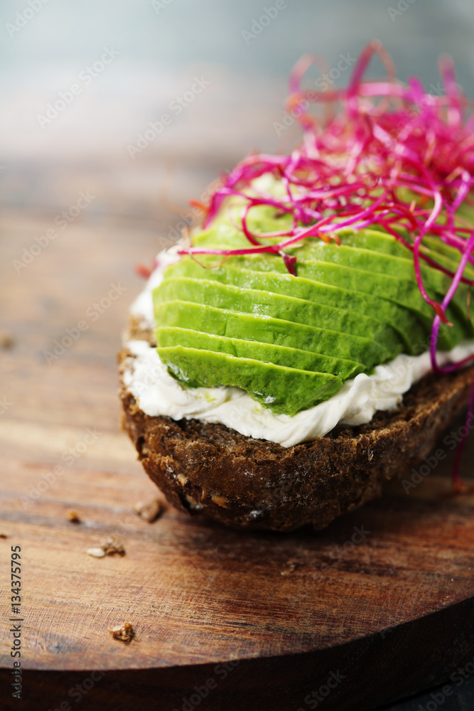 Avocado sandwich on dark rye bread made with fresh sliced avocad