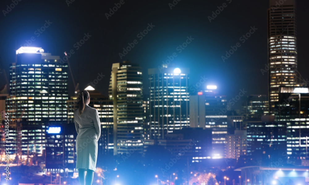 Woman looking at night city