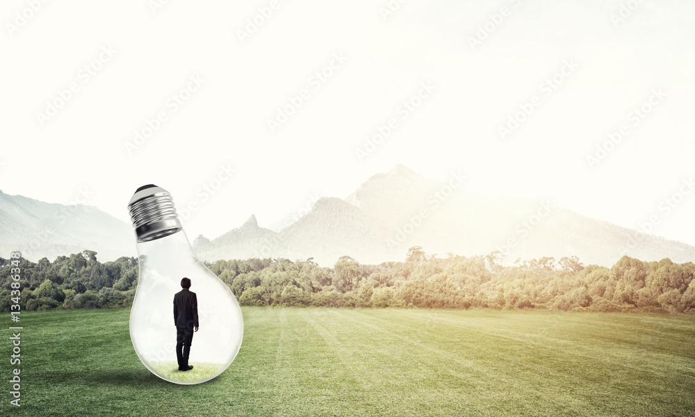 Businessman inside light bulb