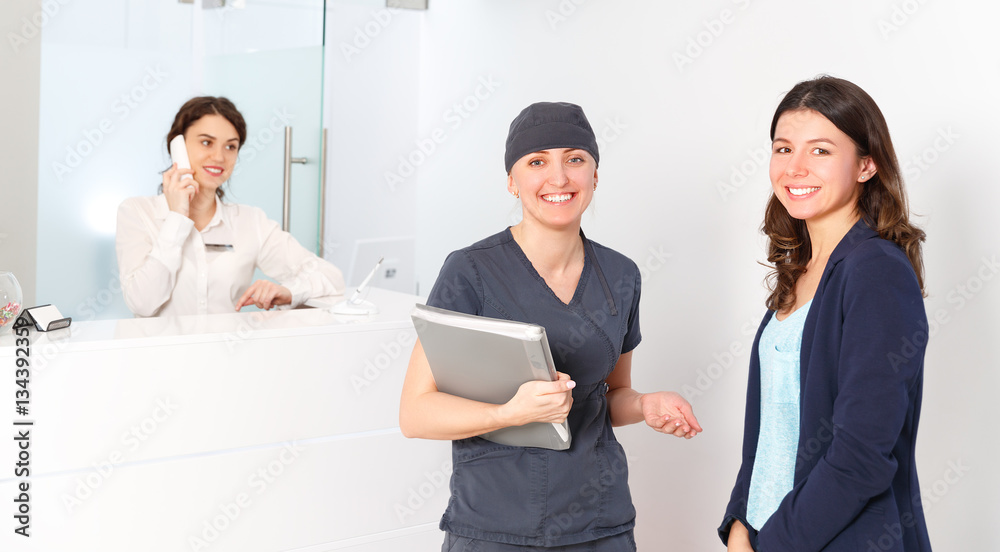 friendly woman behind reception desk administrator with Doctor a