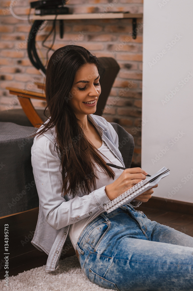 Beautiful student studying and learning writing notes