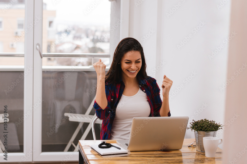 Euphoric and surprised winner winning online watching a laptop 