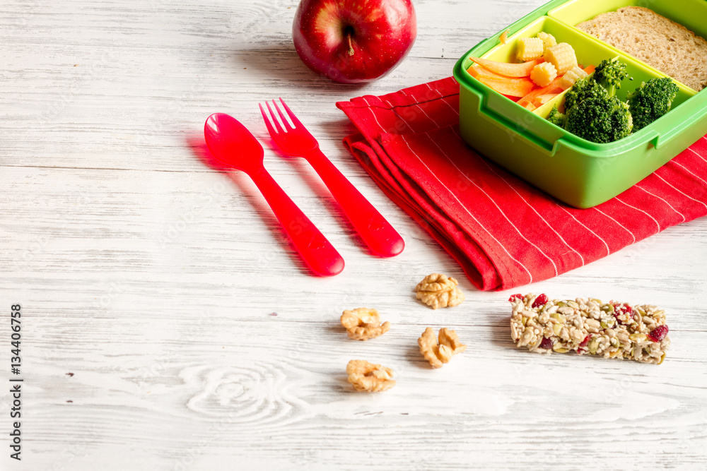 lunch box for kid with fresh vegetables on wooden background