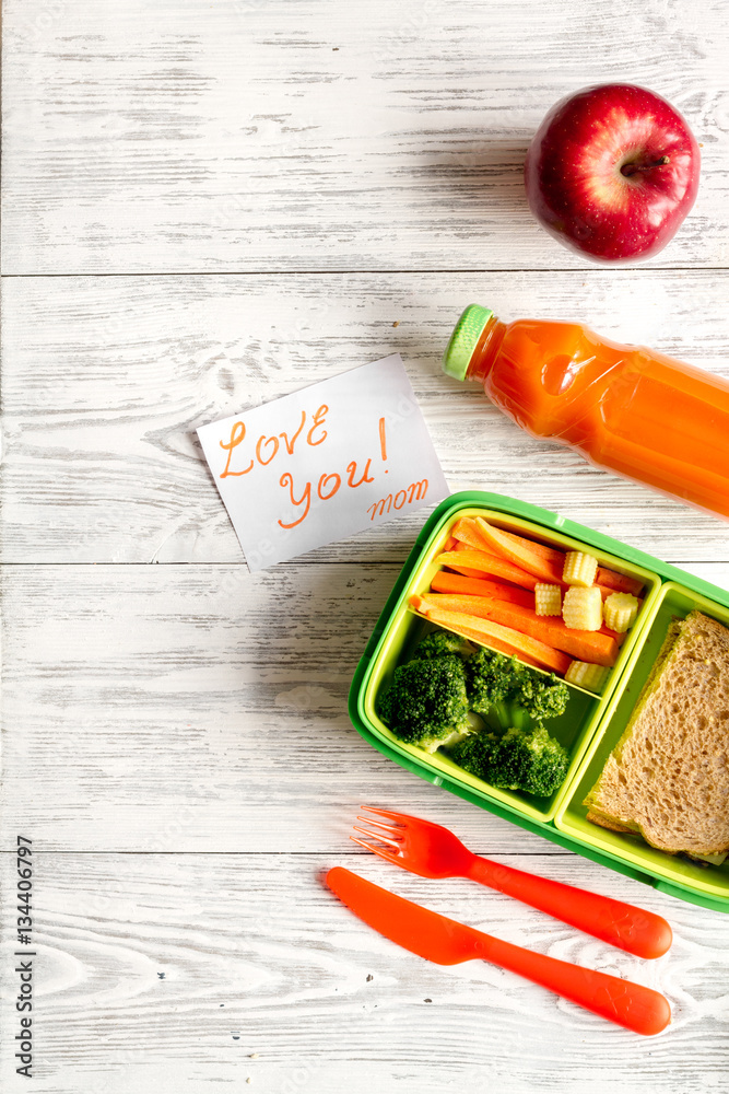 kid menu lunchbox for school top view on wooden background