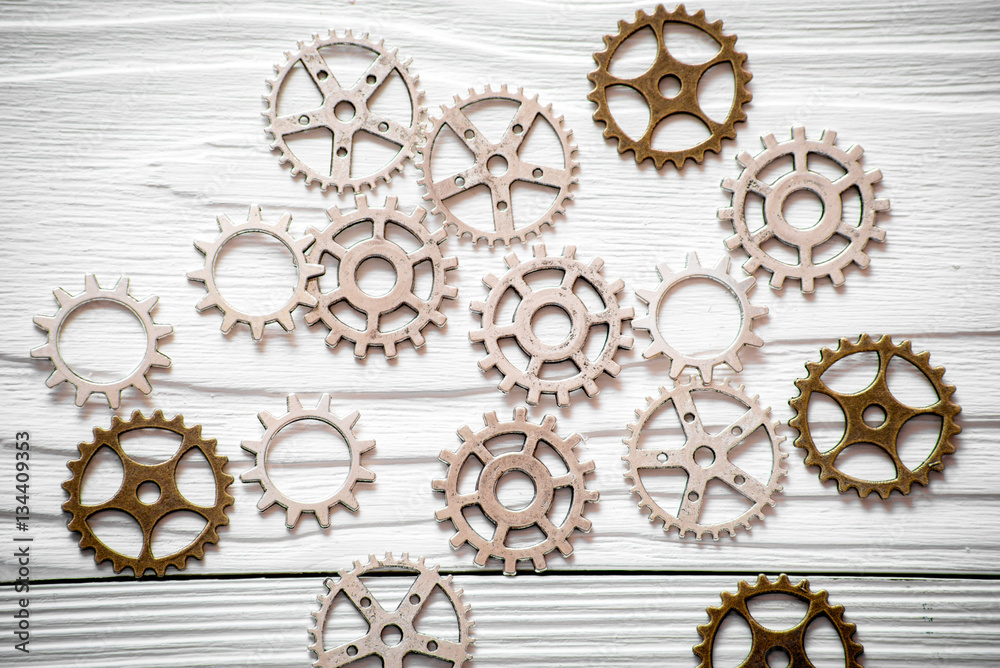 concept hour metal gears on wooden background top view