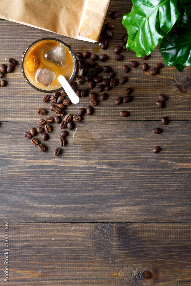 coffee with ice in glass on wooden background top view