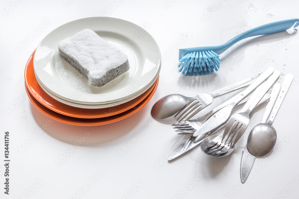 concept of washing dishes on white background top view