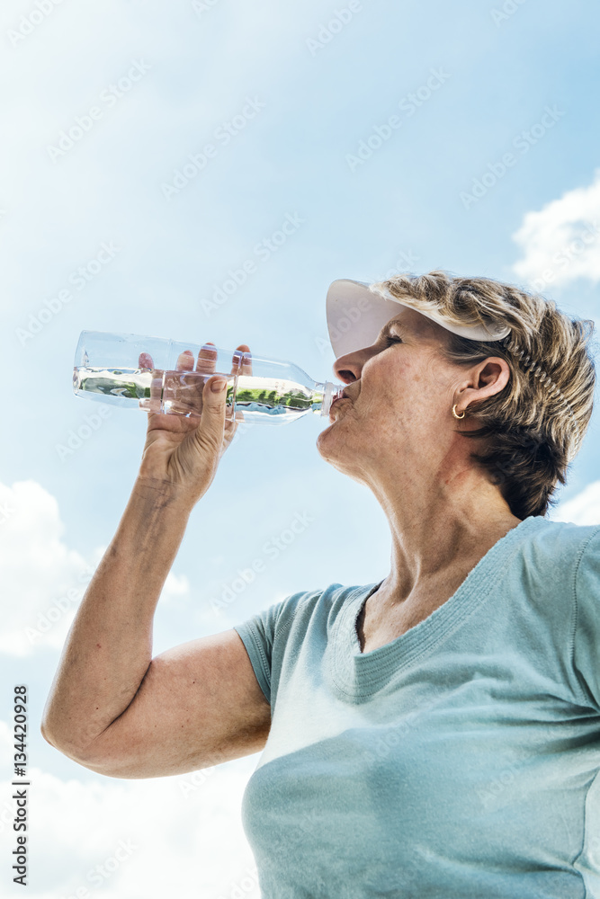 Woman Drinking Water After Exercise Concept