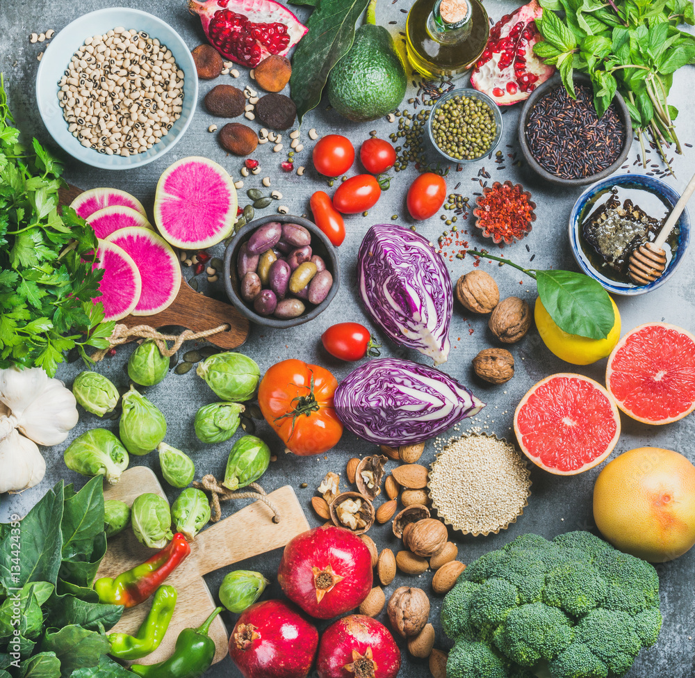 Clean eating concept over grey concrete background, top view. Vegetables, fruit, seeds, cereals, bea