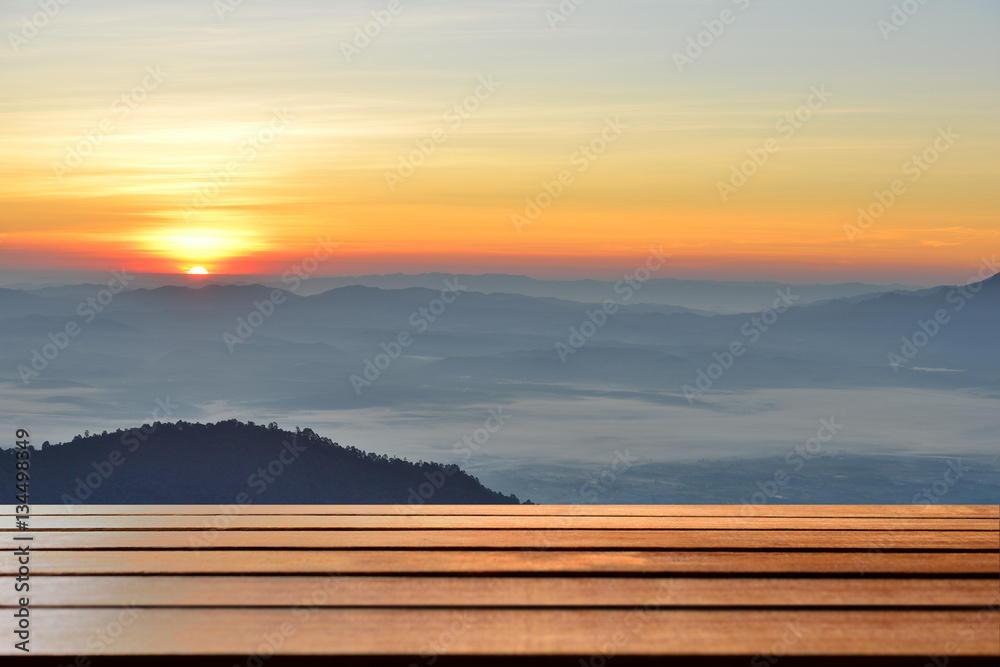 Empty wood table top with mountain background at sunrise