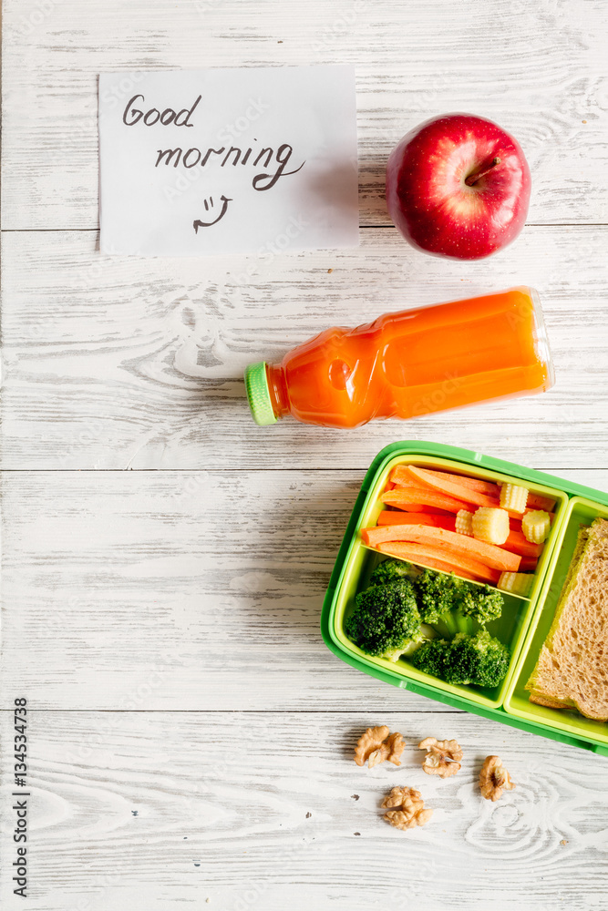 kid menu lunchbox for school top view on wooden background