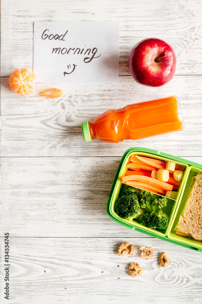 kid menu lunchbox for school top view on wooden background