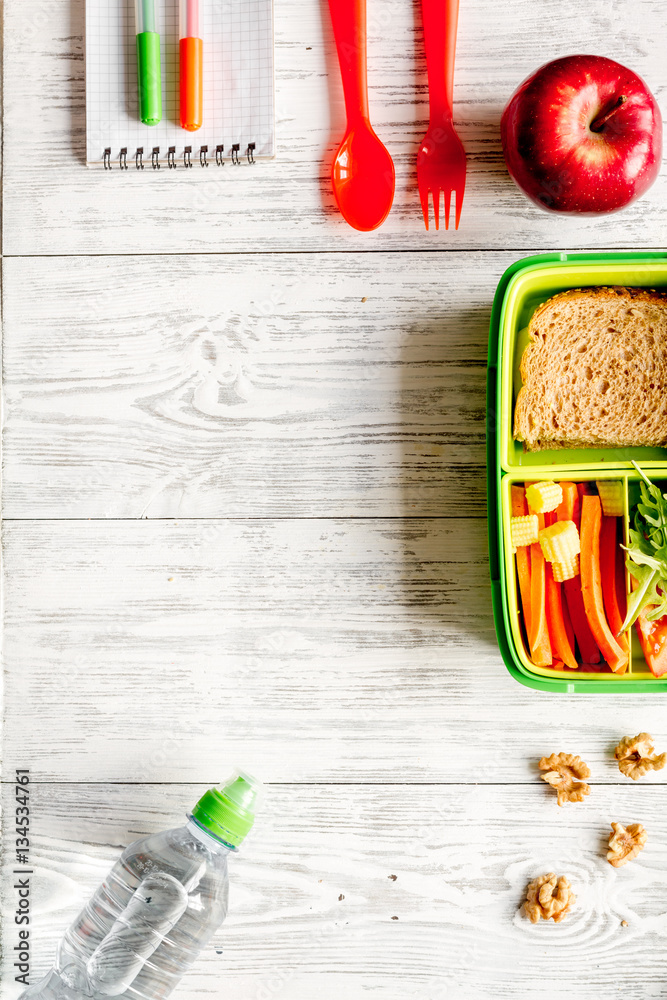 kid menu lunchbox for school top view on wooden background