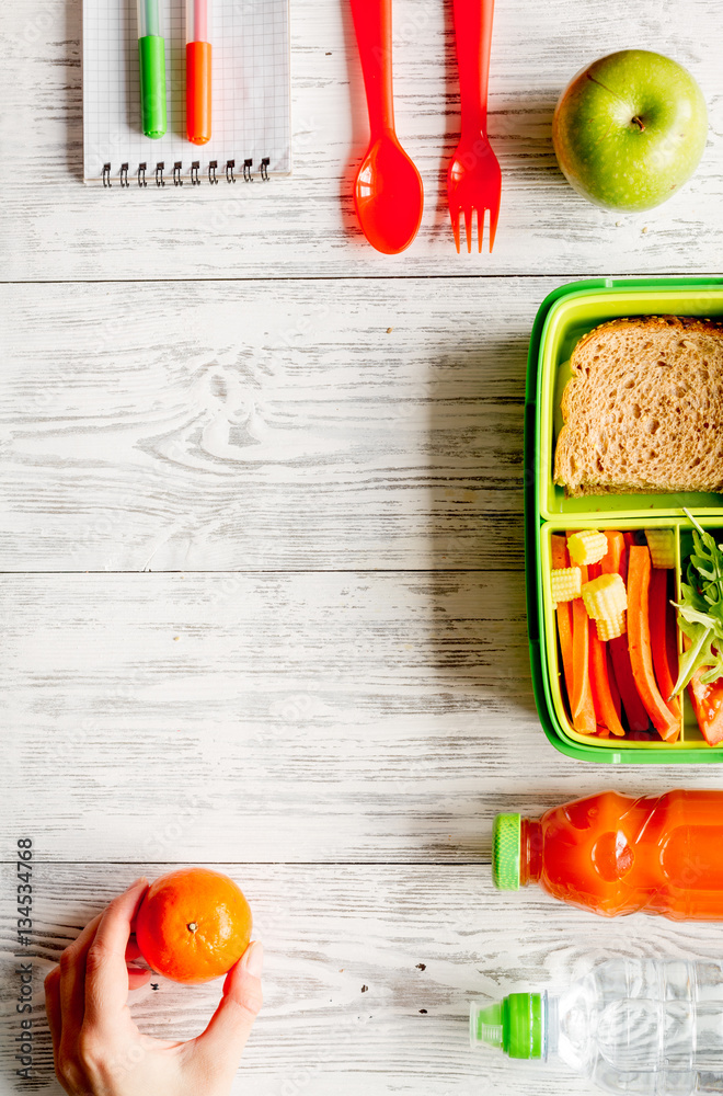 kid menu lunchbox for school top view on wooden background