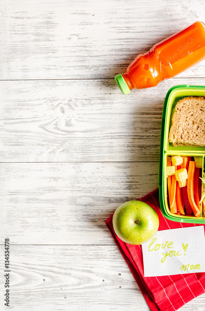 kid menu lunchbox for school top view on wooden background