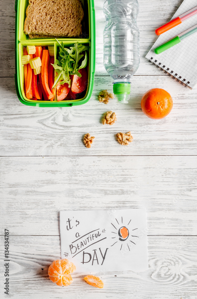 kid menu lunchbox for school top view on wooden background