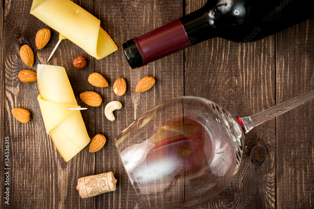 red wine with cheese on wooden background top view