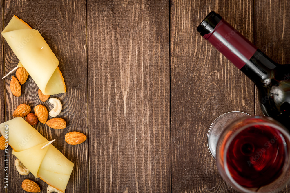 red wine with cheese on wooden background top view