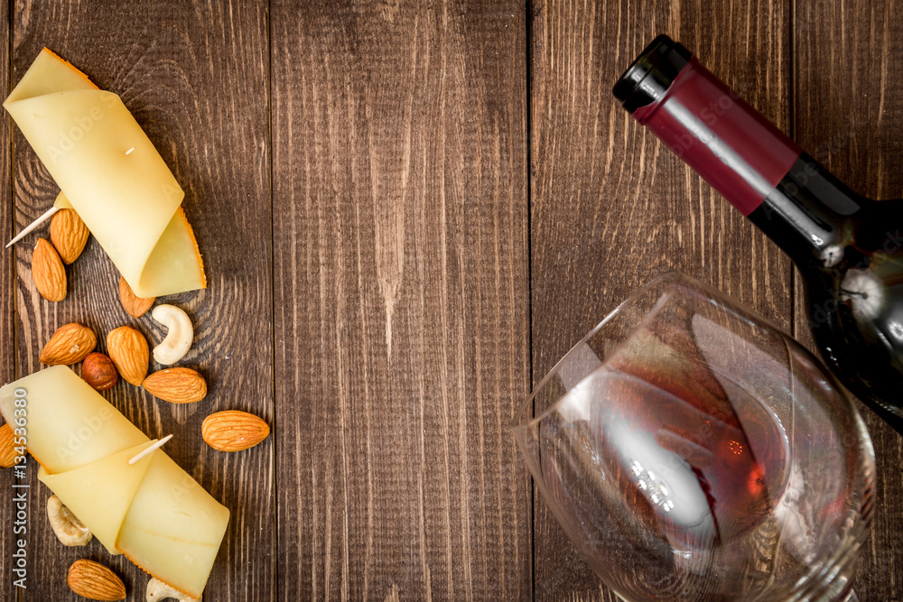 red wine with cheese on wooden background top view