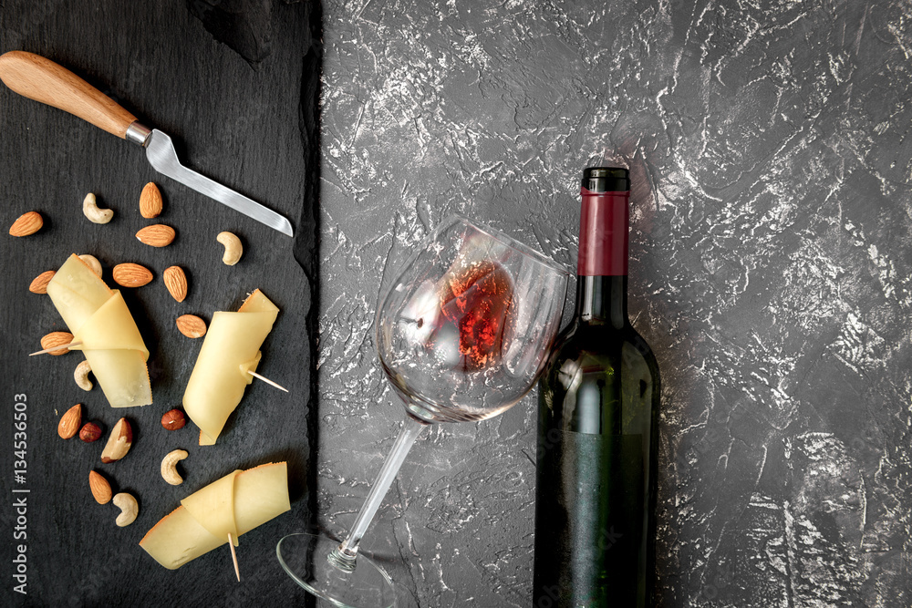 red wine with cheese on dark background top view