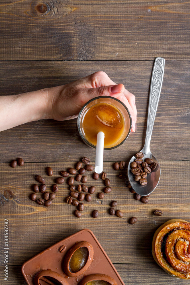 coffee with ice in glass on wooden background top view