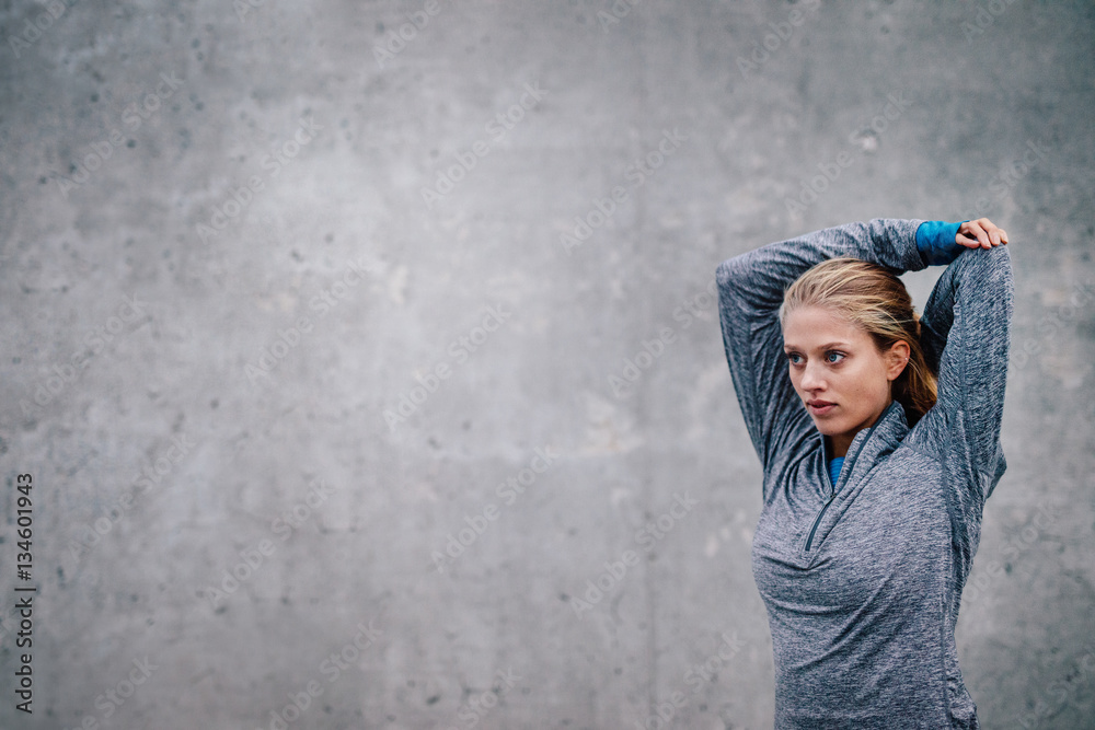 Female runner stretching arms after a running session