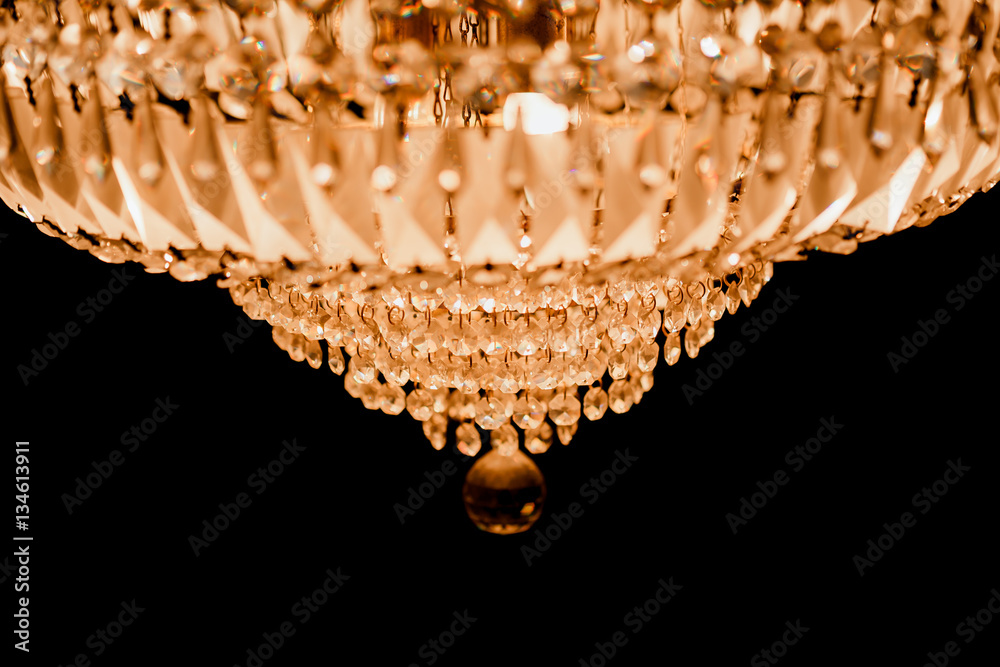 close-up  Chrystal chandelier. black background with copy space.