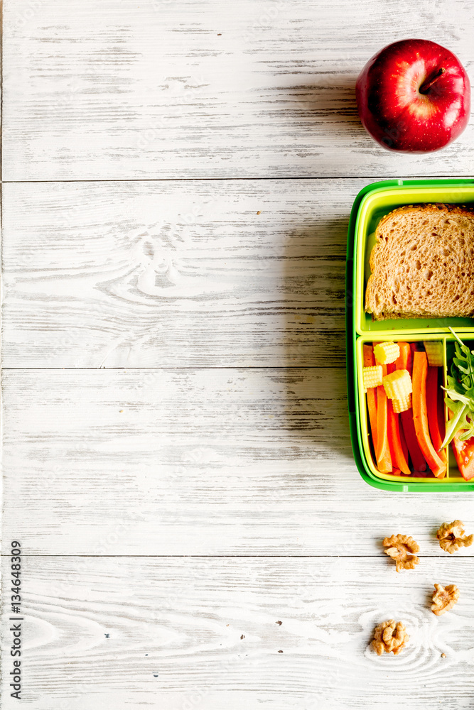 kid menu lunchbox for school top view on wooden background